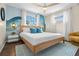 Serene bedroom featuring a king-size bed, custom mural, and soft natural light at 1698 Eden Ct, Clearwater, FL 33756