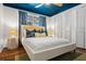 Tranquil bedroom showcases a plush bed, blue ceiling, and ample closet space at 1698 Eden Ct, Clearwater, FL 33756