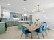 Open floor plan featuring a dining area connected to the kitchen, with blue accents and modern lighting at 1698 Eden Ct, Clearwater, FL 33756