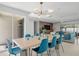 Open concept dining area with modern lighting fixtures, table and seating adjacent to the living room at 1698 Eden Ct, Clearwater, FL 33756
