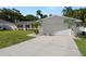 Well-maintained single-story home with a two-car garage, lush lawn, and tropical landscaping in a residential neighborhood at 1698 Eden Ct, Clearwater, FL 33756