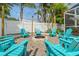 Charming backyard firepit area with Adirondack chairs, creating a cozy and inviting outdoor space for gatherings at 1698 Eden Ct, Clearwater, FL 33756