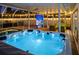 Relaxing hot tub area with illuminated blue water and a pool area at 1698 Eden Ct, Clearwater, FL 33756