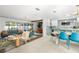 Open-concept living area with dining and kitchen, featuring bright colors and modern finishes at 1698 Eden Ct, Clearwater, FL 33756
