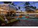 Screened-in pool with loungers and night lights for a relaxing outdoor space at 1698 Eden Ct, Clearwater, FL 33756