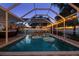 A screened-in pool with floats and lounge chairs, perfect for relaxing evenings at 1698 Eden Ct, Clearwater, FL 33756