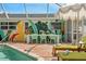 Stylish poolside dining area with seating for eight and a unique mural at 1698 Eden Ct, Clearwater, FL 33756