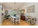 Bright dining room with hardwood floors, plantation shutters, and stylish decor, ideal for hosting gatherings at 18106 Woodcreek Pl, Lutz, FL 33548