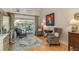 Cozy living room with hardwood floors, pool views, and comfortable seating, perfect for relaxing or entertaining at 18106 Woodcreek Pl, Lutz, FL 33548