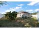 Backyard showcasing green grass, a shade tree, and home's exterior at 18314 Waydale Loop, Hudson, FL 34667