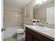 Bathroom featuring a vanity with a sink, a commode, and a shower-tub combo at 18314 Waydale Loop, Hudson, FL 34667