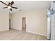Spacious bedroom features light wood flooring, neutral walls, and a ceiling fan at 18314 Waydale Loop, Hudson, FL 34667