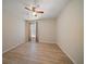 Bedroom featuring wood flooring, a ceiling fan, and window at 18314 Waydale Loop, Hudson, FL 34667