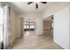Bedroom with wood floors that leads to an enclosed sunroom at 18314 Waydale Loop, Hudson, FL 34667