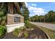 Briar Oaks brick community sign surrounded by lush landscaping along a paved road on a sunny day at 18314 Waydale Loop, Hudson, FL 34667