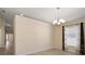 Bright dining room with modern chandelier, decorative curtains, and wood-look floors at 18314 Waydale Loop, Hudson, FL 34667