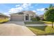 Charming single-Gathering home with a two-car garage and well-maintained front yard at 18314 Waydale Loop, Hudson, FL 34667