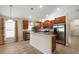 Open kitchen featuring stainless steel appliances, an island, and lots of natural light at 18314 Waydale Loop, Hudson, FL 34667