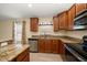 Kitchen with granite countertops, stainless steel appliances, and wooden cabinets at 18314 Waydale Loop, Hudson, FL 34667