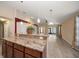 Open living room area featuring a kitchen island and hardwood floors at 18314 Waydale Loop, Hudson, FL 34667