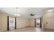 Spacious living room with abundant natural light, wood-look floors, and modern ceiling fan at 18314 Waydale Loop, Hudson, FL 34667