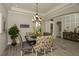Open dining room area with modern furniture, elegant lighting and decorative shelving at 18483 Purple Creek Ln # Lot 1, Lutz, FL 33549