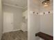 Mudroom features coat hooks, a bench, and a sink with modern lighting at 18483 Purple Creek Ln # Lot 1, Lutz, FL 33549