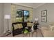 Cozy sitting room with bright window, modern furniture and decorative wall art at 18483 Purple Creek Ln # Lot 1, Lutz, FL 33549