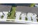 Aerial view of townhomes with brick driveways, small front lawns, and a pond view at 19195 Blue Pond Dr, Lutz, FL 33558
