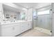 Bright bathroom boasts a double vanity, and a spacious glass shower at 19195 Blue Pond Dr, Lutz, FL 33558