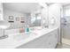 This bathroom features a double vanity, a large mirror, and glass shower at 19195 Blue Pond Dr, Lutz, FL 33558