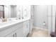 This bathroom features a double vanity, a large mirror, and a tiled shower at 19195 Blue Pond Dr, Lutz, FL 33558