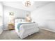 Cozy bedroom featuring a queen-sized bed, soft carpet, and natural light from window at 19195 Blue Pond Dr, Lutz, FL 33558