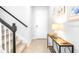 Inviting entryway showcasing a stylish console table, artwork, and a staircase leading to the upper level at 19195 Blue Pond Dr, Lutz, FL 33558