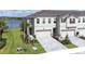 Charming townhome with a two-car garage, set against a backdrop of serene water views at 19195 Blue Pond Dr, Lutz, FL 33558