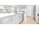 Stylish modern kitchen with white cabinets, stainless steel appliances, and ample counter space at 19195 Blue Pond Dr, Lutz, FL 33558
