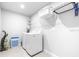 Functional laundry room features modern appliances, ample storage, and bright lighting at 19195 Blue Pond Dr, Lutz, FL 33558