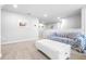 Upstairs living room showcasing neutral decor, a cozy sofa, and soft carpeting for a comfortable and relaxing atmosphere at 19195 Blue Pond Dr, Lutz, FL 33558