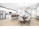 Bright, open floor plan featuring a modern kitchen and dining area with ample seating at 19195 Blue Pond Dr, Lutz, FL 33558