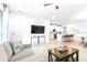 Bright, modern living room with sleek furniture, a television, and an open flow to the kitchen, perfect for entertaining at 19195 Blue Pond Dr, Lutz, FL 33558