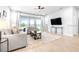 Bright living room featuring neutral sofas, a patterned rug, and views of the outdoors at 19195 Blue Pond Dr, Lutz, FL 33558