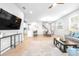 Spacious open-plan living room featuring sleek furniture, a modern ceiling fan, and a seamless flow to the kitchen at 19195 Blue Pond Dr, Lutz, FL 33558