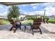 Community patio area with brick pavers, Adirondack chairs, and string lights at 19195 Blue Pond Dr, Lutz, FL 33558