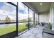 This is a spacious enclosed patio with brick floors and stunning views of the lake at 19195 Blue Pond Dr, Lutz, FL 33558