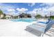 Community pool area featuring crystal clear water, lounge chairs, and modern design at 19195 Blue Pond Dr, Lutz, FL 33558