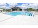 Community pool area with a modern design, crystal clear water, and lounge area at 19195 Blue Pond Dr, Lutz, FL 33558