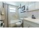 Well-maintained bathroom featuring a shower-tub combo, vanity with storage, and neutral-toned tile at 2051 Lyra Dr, Holiday, FL 34690
