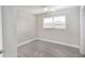 This carpeted bedroom has a ceiling fan and a window that lets in natural light at 21042 Gladis Ave, Port Charlotte, FL 33952