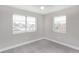 This carpeted bedroom has two windows for natural light at 21042 Gladis Ave, Port Charlotte, FL 33952
