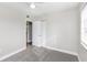 This carpeted bedroom has an entry door as well as a closet at 21042 Gladis Ave, Port Charlotte, FL 33952